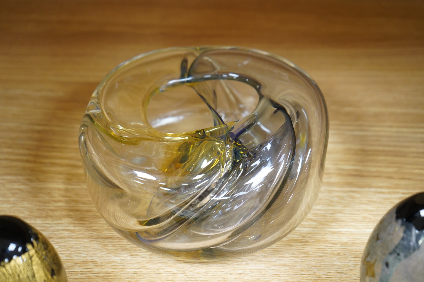 Brian Lonsway (American), an art glass ornamental dish, two Isle of Wight glass eggs and a floral paperweight, tallest 8.5cm